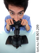 Man pretending to play a console. Стоковое фото, агентство Ingram Publishing / Фотобанк Лори