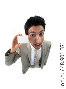 young businessman holding business card playing the fool. Стоковое фото, агентство Ingram Publishing / Фотобанк Лори