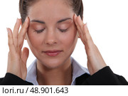 Expressive woman with fingertips on temples. Стоковое фото, агентство Ingram Publishing / Фотобанк Лори