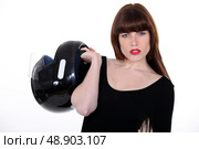 Attractive woman carrying a motorcycle helmet. Стоковое фото, агентство Ingram Publishing / Фотобанк Лори