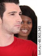 Woman smiling and serious man. Стоковое фото, агентство Ingram Publishing / Фотобанк Лори