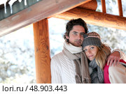 Couple stood by their holiday chalet. Стоковое фото, агентство Ingram Publishing / Фотобанк Лори