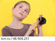 Wishful girl with an empty coin purse. Стоковое фото, агентство Ingram Publishing / Фотобанк Лори