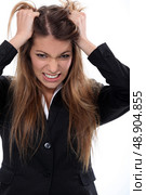 Businesswoman tearing her hair out. Стоковое фото, агентство Ingram Publishing / Фотобанк Лори