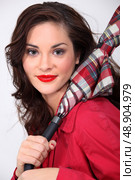 Fashionable woman carrying an umbrella. Стоковое фото, агентство Ingram Publishing / Фотобанк Лори