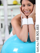 Woman in gym with blue ball. Стоковое фото, агентство Ingram Publishing / Фотобанк Лори