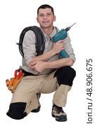 Woodworker crouching on white background. Стоковое фото, агентство Ingram Publishing / Фотобанк Лори