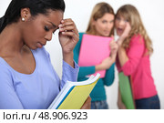 Sad student excluded by friends. Стоковое фото, агентство Ingram Publishing / Фотобанк Лори