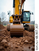 Heavy machinery is at work as an excavator bucket efficiently delves into soft, damp earth, preparing the landscape for upcoming construction on an overcast day Generative AI. Стоковое AI-изображение, AI-художник Юлия Петровская / Фотобанк Лори