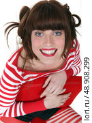 Cute woman in red reading a book. Стоковое фото, агентство Ingram Publishing / Фотобанк Лори