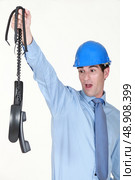 An architect holding a bunch of broke phones. Стоковое фото, агентство Ingram Publishing / Фотобанк Лори