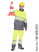 Traffic guard holding a pylon. Стоковое фото, агентство Ingram Publishing / Фотобанк Лори