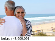 a senior woman hugging her husband near the sea. Стоковое фото, агентство Ingram Publishing / Фотобанк Лори