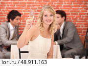 Blond woman with champagne in restaurant. Стоковое фото, агентство Ingram Publishing / Фотобанк Лори