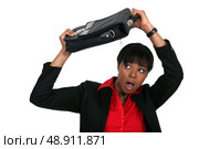 Protecting her head with suitcase. Стоковое фото, агентство Ingram Publishing / Фотобанк Лори