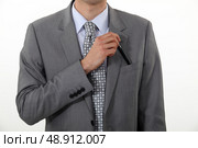 Businessman putting a pen in his pocket. Стоковое фото, агентство Ingram Publishing / Фотобанк Лори