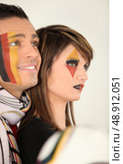 Two engrossed German football fans. Стоковое фото, агентство Ingram Publishing / Фотобанк Лори