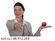 Businesswoman approving an apple. Стоковое фото, агентство Ingram Publishing / Фотобанк Лори