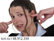 Businesswoman with her fingers in her ears. Стоковое фото, агентство Ingram Publishing / Фотобанк Лори