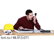 Architect shouting down the telephone. Стоковое фото, агентство Ingram Publishing / Фотобанк Лори