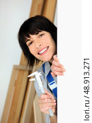Handywoman holding callipers. Стоковое фото, агентство Ingram Publishing / Фотобанк Лори