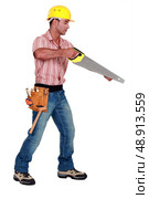A male carpenter with a handsaw. Стоковое фото, агентство Ingram Publishing / Фотобанк Лори