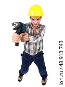 Tradeswoman holding a power tool. Стоковое фото, агентство Ingram Publishing / Фотобанк Лори