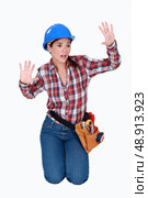 Tradeswoman stuck behind an invisible wall. Стоковое фото, агентство Ingram Publishing / Фотобанк Лори