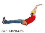 Tradesman jumping in the air. Стоковое фото, агентство Ingram Publishing / Фотобанк Лори