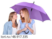Two girls under an umbrella. Стоковое фото, агентство Ingram Publishing / Фотобанк Лори