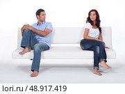 couple sitting apart in couch after quarrel. Стоковое фото, агентство Ingram Publishing / Фотобанк Лори