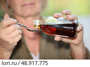 Woman taking cough medicine. Стоковое фото, агентство Ingram Publishing / Фотобанк Лори