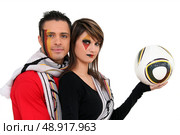 Couple supporting German football team. Стоковое фото, агентство Ingram Publishing / Фотобанк Лори