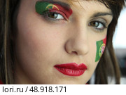 Attractive Portuguese woman with national flag painted on face. Стоковое фото, агентство Ingram Publishing / Фотобанк Лори