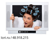 Woman escaping from television set. Стоковое фото, агентство Ingram Publishing / Фотобанк Лори