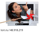 Woman escaping from a television. Стоковое фото, агентство Ingram Publishing / Фотобанк Лори