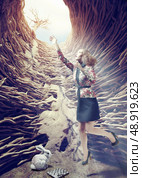 girl flies out of a deep hole toward the sunlight. creative concept. Стоковое фото, агентство Ingram Publishing / Фотобанк Лори