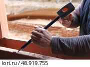 Man working on a window frame. Стоковое фото, агентство Ingram Publishing / Фотобанк Лори