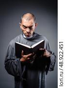 Young priest isolated on the white. Стоковое фото, агентство Ingram Publishing / Фотобанк Лори