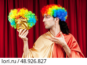 Actor with maks in a funny theater concept. Стоковое фото, агентство Ingram Publishing / Фотобанк Лори