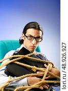 Young businessman tied with rope. Стоковое фото, агентство Ingram Publishing / Фотобанк Лори