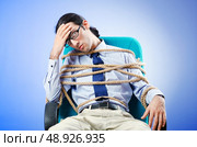 Young businessman tied with rope. Стоковое фото, агентство Ingram Publishing / Фотобанк Лори