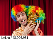 Actor with maks in a funny theater concept. Стоковое фото, агентство Ingram Publishing / Фотобанк Лори