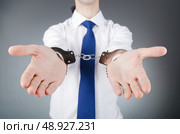 Businessman handcuffed for his crimes. Стоковое фото, агентство Ingram Publishing / Фотобанк Лори