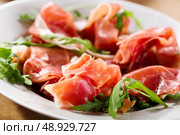 prosciutto ham with rucola on a plate. Стоковое фото, агентство Ingram Publishing / Фотобанк Лори