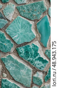 Vivid shades of teal and azure form a mesmerizing collection of amazonite stones, intricately arranged to highlight their unique patterns and smooth surfaces under soft lighting Generative AI. Стоковое AI-изображение, AI-художник Юлия Петровская / Фотобанк Лори