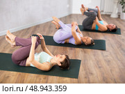 Young woman practicing pilates exercises in yoga studio. Стоковое фото, фотограф Яков Филимонов / Фотобанк Лори