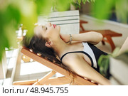 Gorgeous lady lying on the deckchair. Стоковое фото, агентство Ingram Publishing / Фотобанк Лори