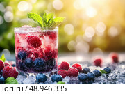 An effervescent berry lemonade glistens in a transparent highball glass. Vibrant blueberries, raspberries, and mint garnish on crushed ice create a visually stunning, refreshing drink. Стоковое AI-изображение, AI-художник Nart / Фотобанк Лори