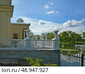 Summer terrace of Tsaritsyn Pavilion on Olga’s Pond, Petrodvorets (Peterhof, St. Petersburg, Russia), white balcony with ornamental vases. Стоковое фото, фотограф Елена  Попкова / Фотобанк Лори